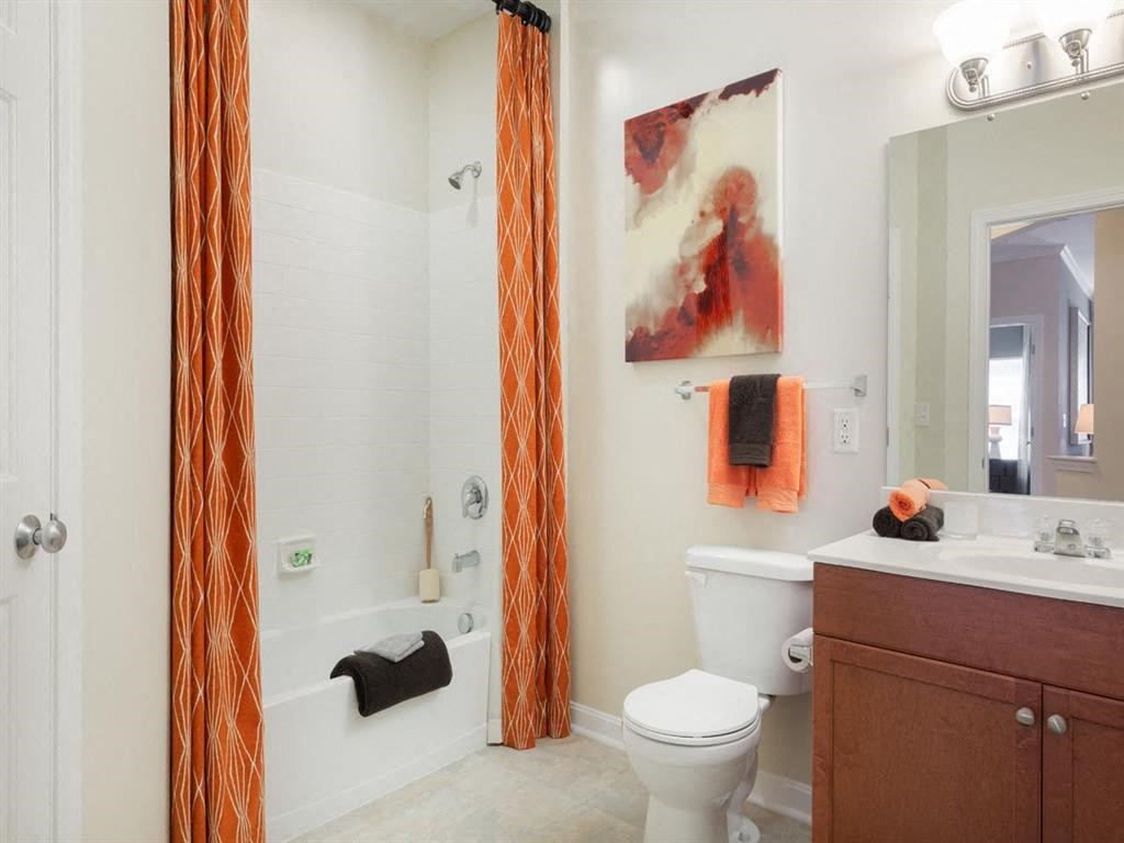 a bathroom with a shower and a toilet and a sink