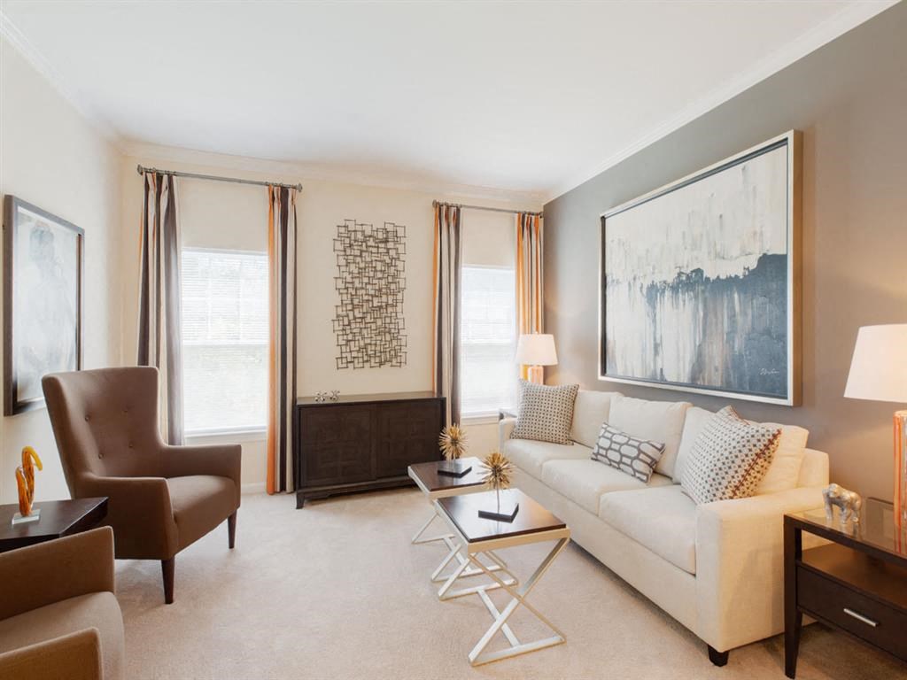 a living room with a couch and a chair and a table