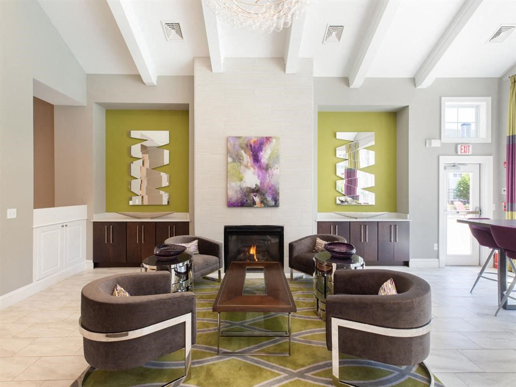 a living room with couches and chairs and a fireplace