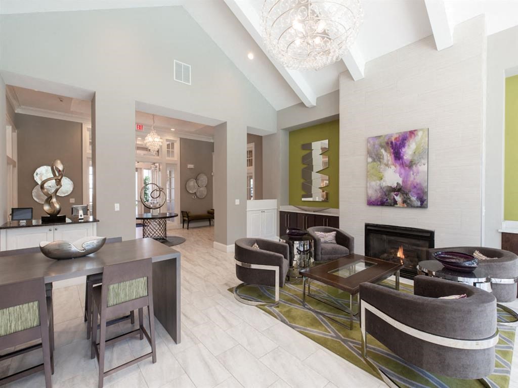 a living room with a fireplace and a table and chairs