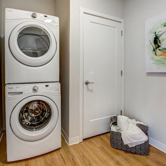 a white washer and dryer in a small laundry room