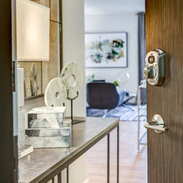 a view of a living room through a door with a door handle