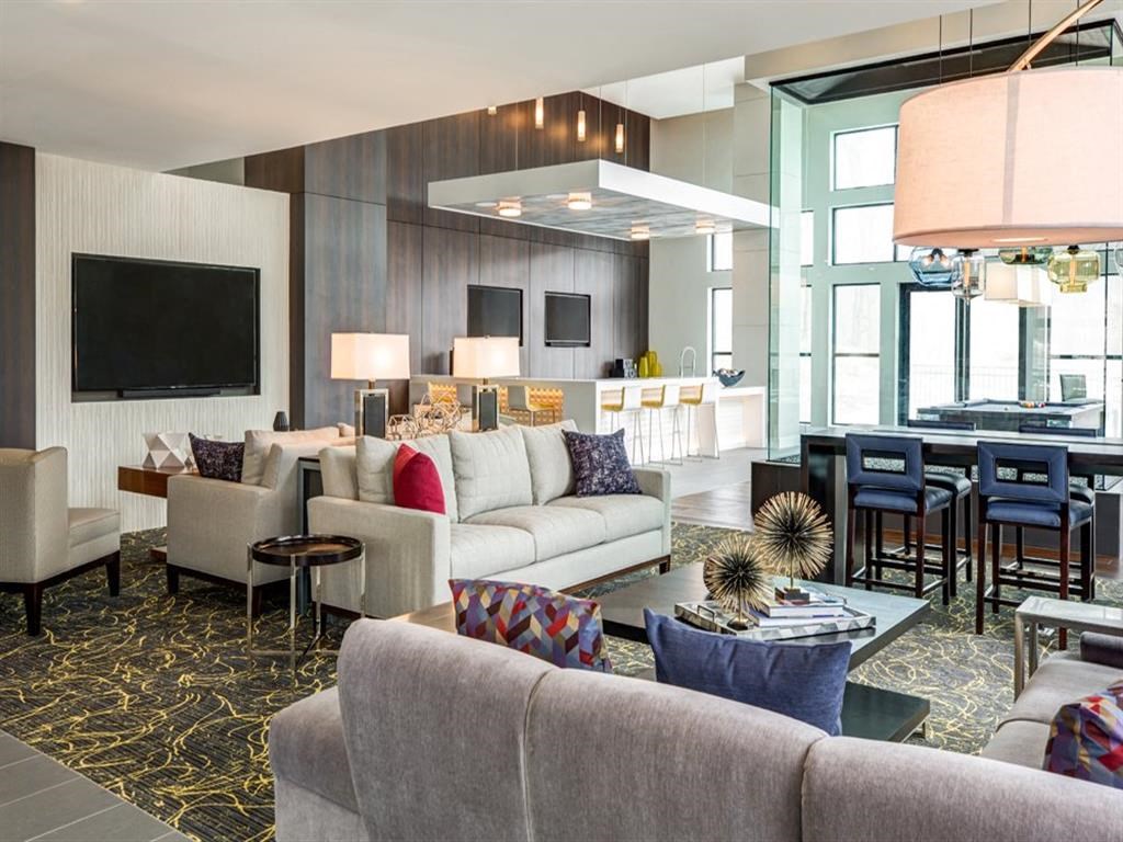 a living room with couches and chairs and a table