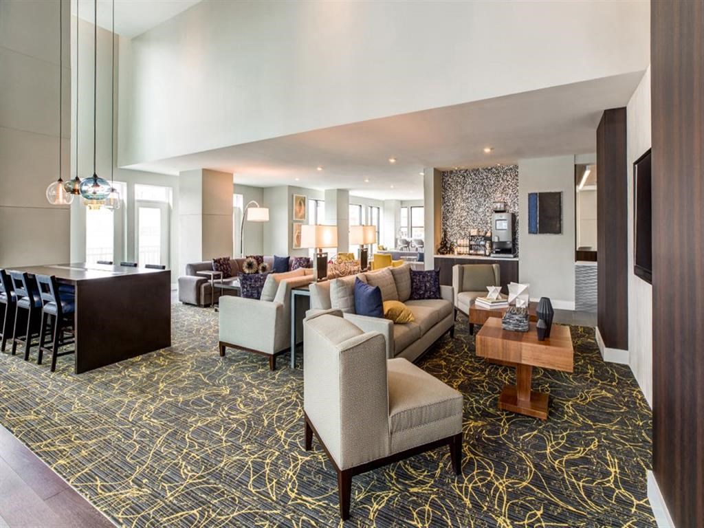 a large living room with couches and chairs