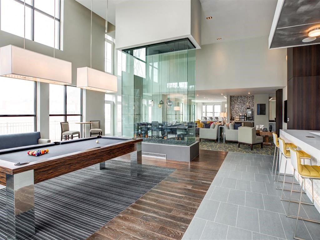 a clubhouse with a pool table and a bar