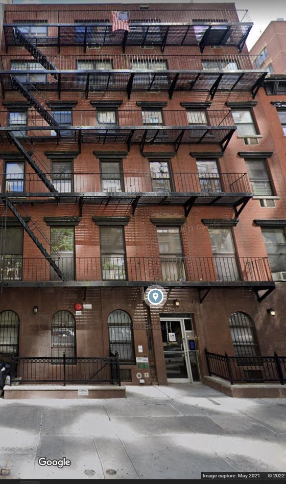 the apartment building has several balconies and a fire escape
