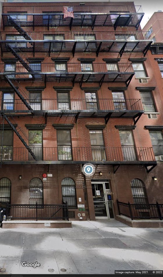the apartment building has several balconies and a fire escape