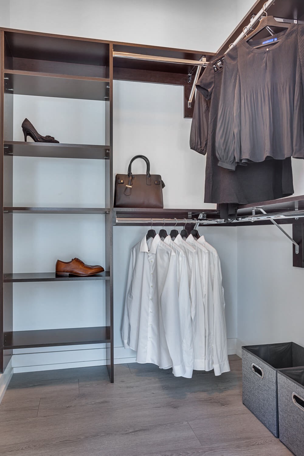a walk in closet with shelves filled with clothes and shoes