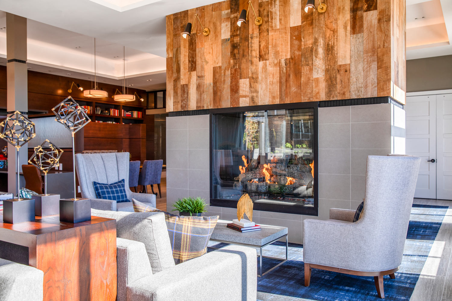 the lobby of a hotel with a fireplace