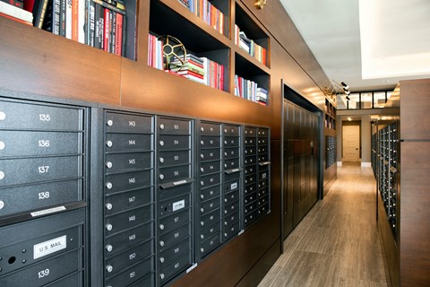 a long hallway with lockers and bookshelves in a library