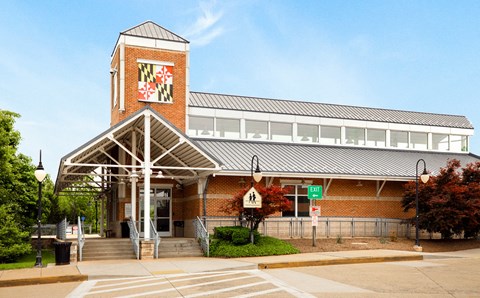 the front of a brick building with a clock tower
