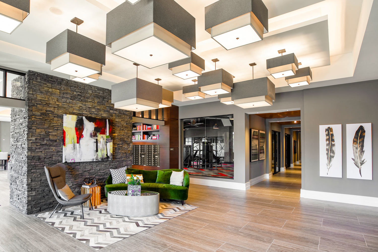 a large lobby with a couch and chairs and lights