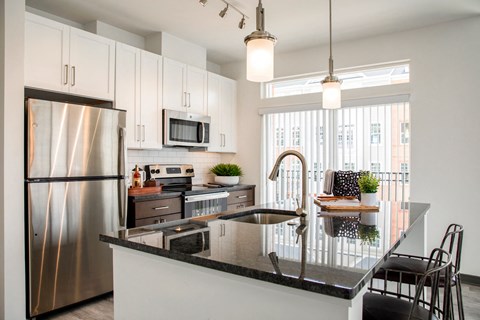 a kitchen with stainless steel appliances and a counter top