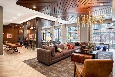 a large lobby with couches and chairs and a table