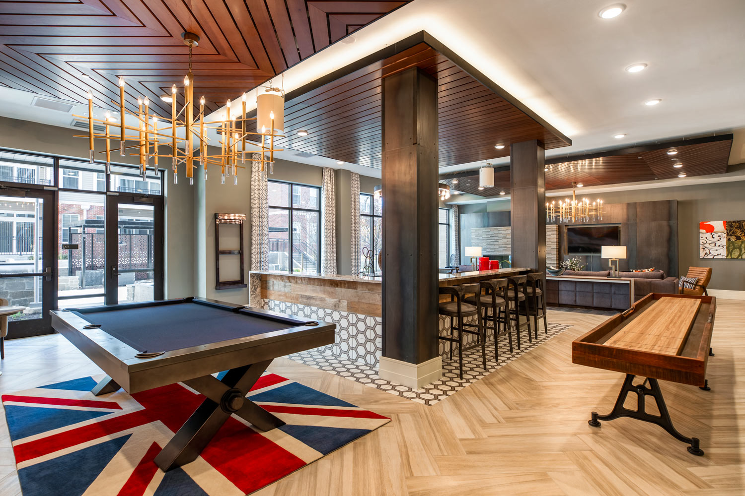 a game room with a pool table and a bar