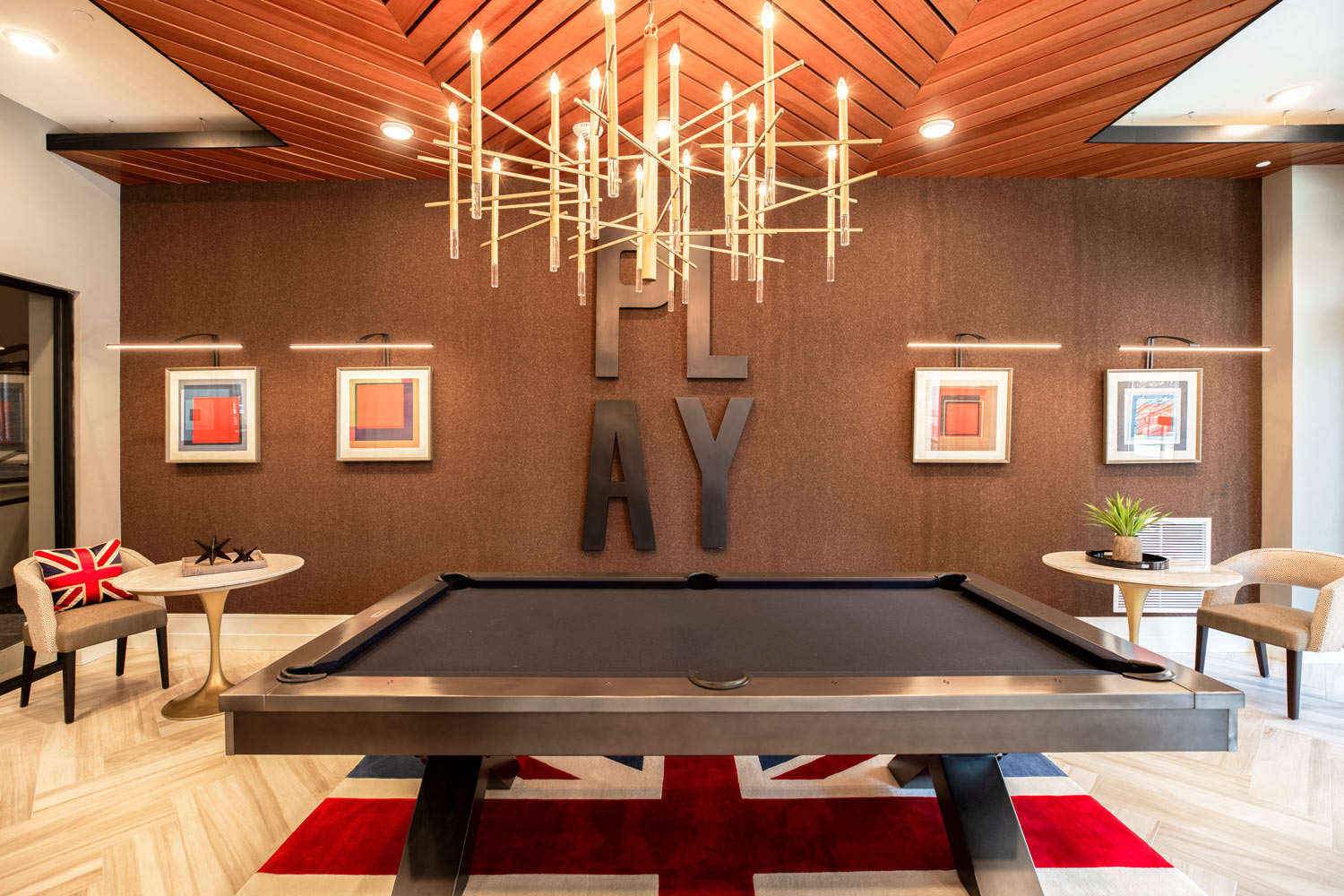 a game room with a pool table and a chandelier