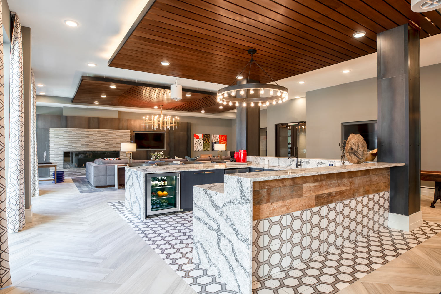 a view of the lobby of a hotel with a bar and a fireplace