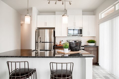 a kitchen with a counter top and a refrigerator