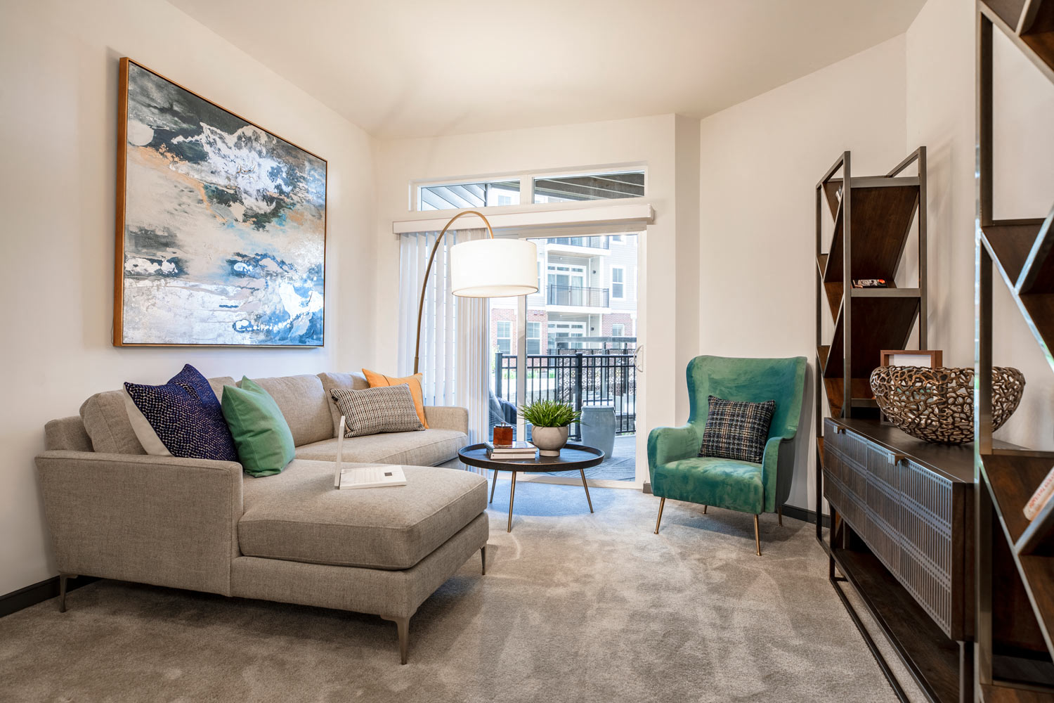 a living room with a couch and a chair and a window