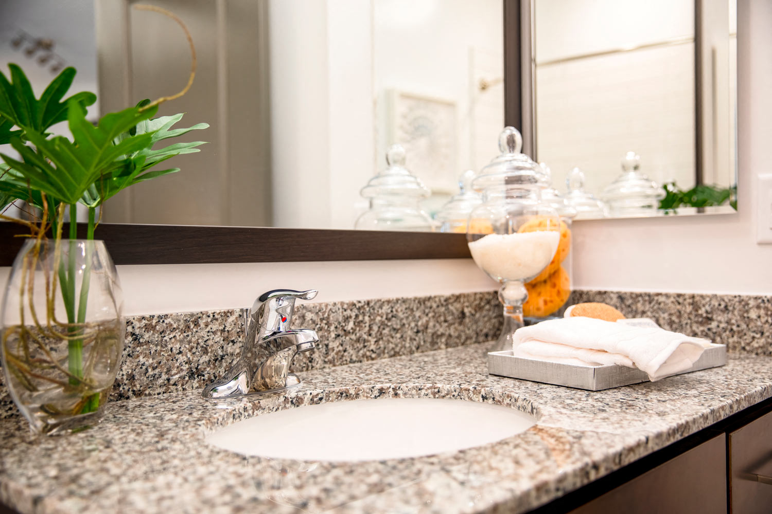 a bathroom counter with a sink and a mirror