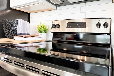 a modern kitchen with stainless steel appliances and a counter top