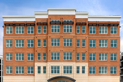 a large brick building with a blue sky in the background