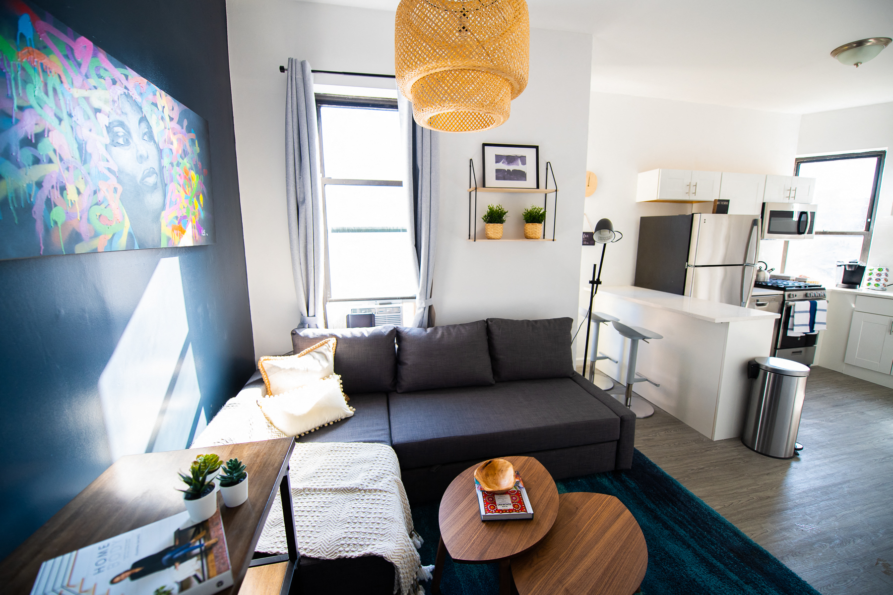 a living room with a black couch and a coffee table