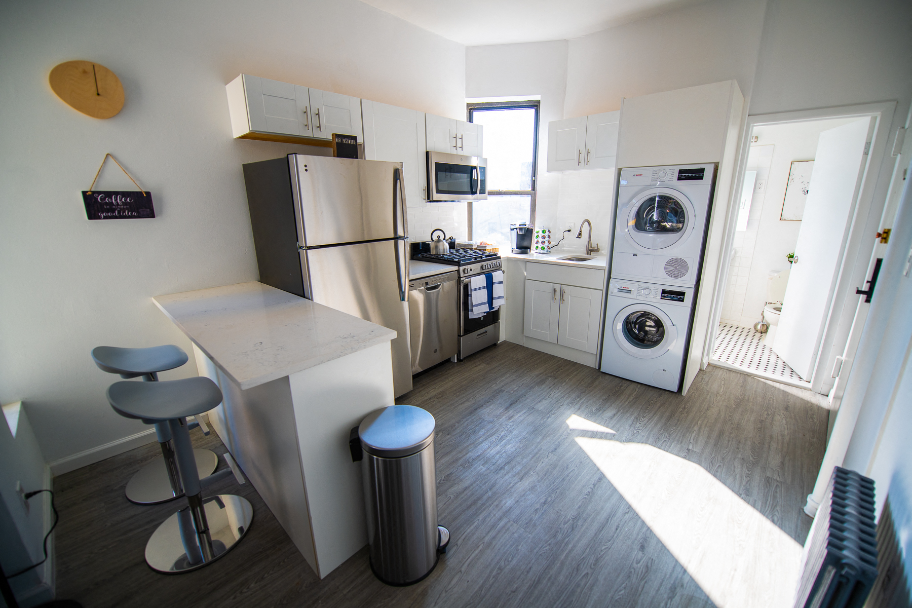 a kitchen with a washer and dryer and a refrigerator