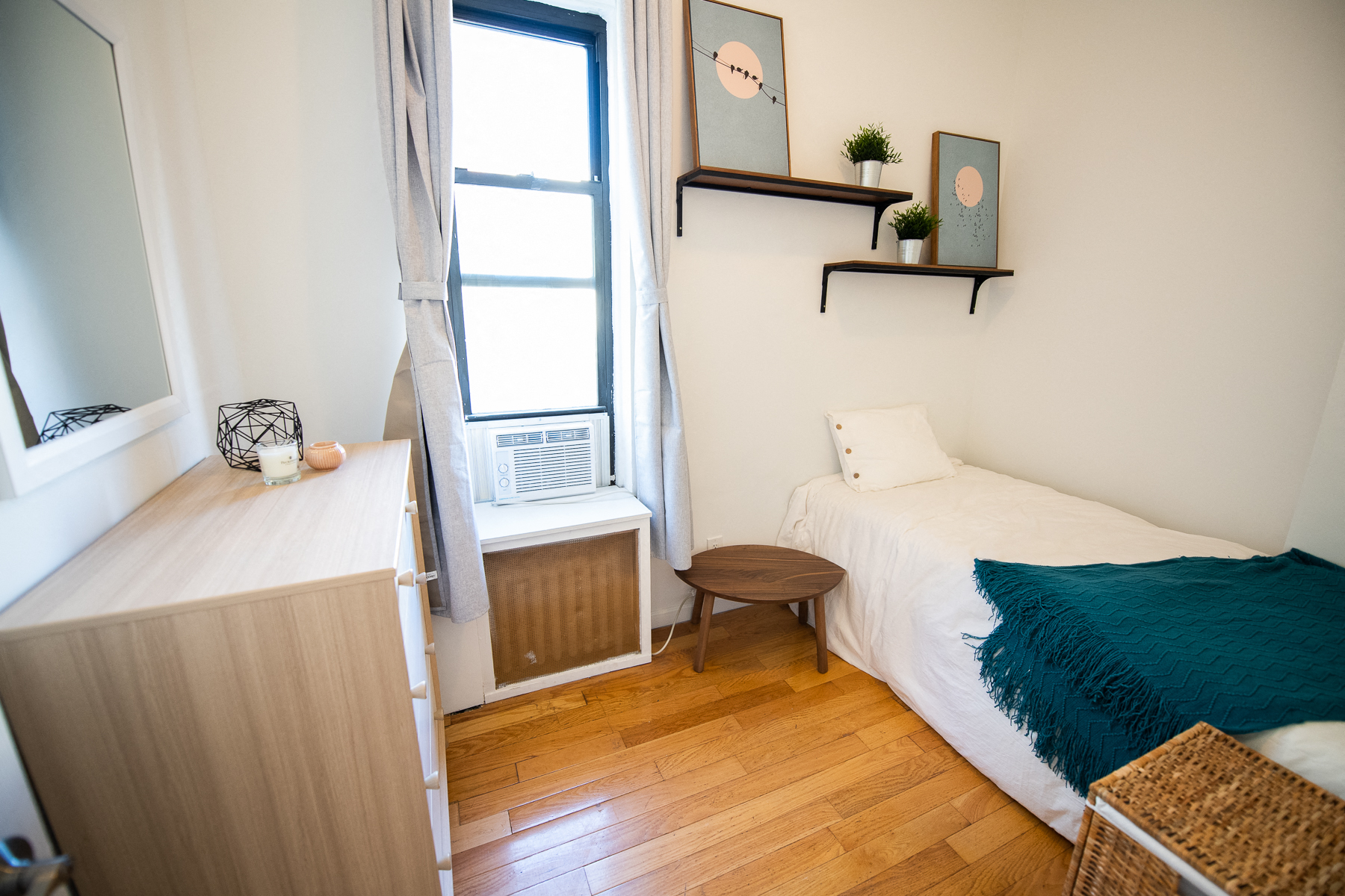 a small bedroom with a bed and a window