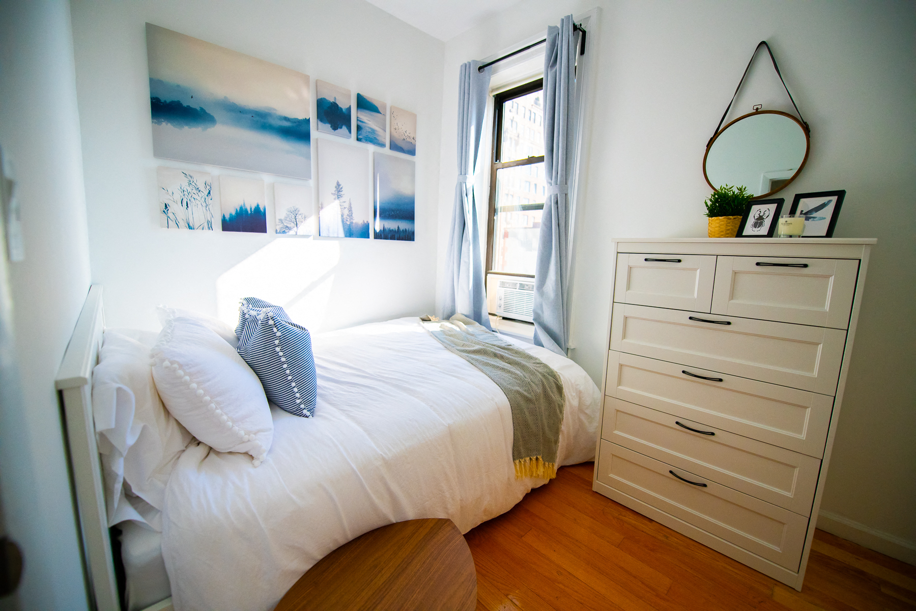 a bedroom with a bed and a dresser and a window