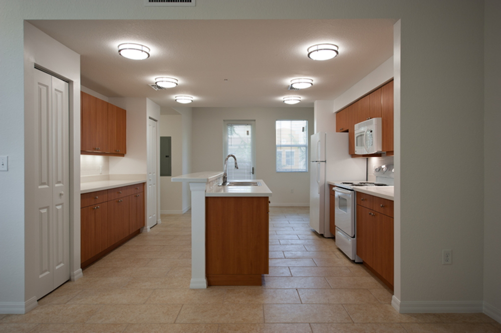 large kitchen with island and overhead lighting