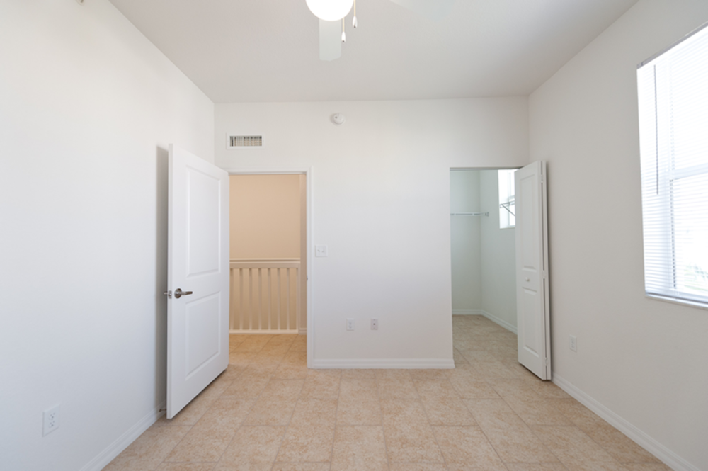 bedroom with ceiling fan and large closet