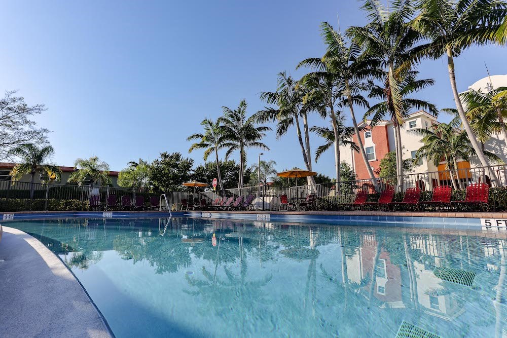 large pool with plenty of lounge furniture