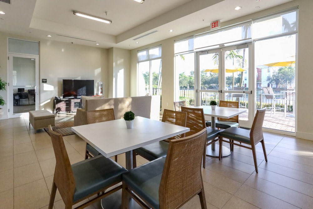 tables and seating with large tv