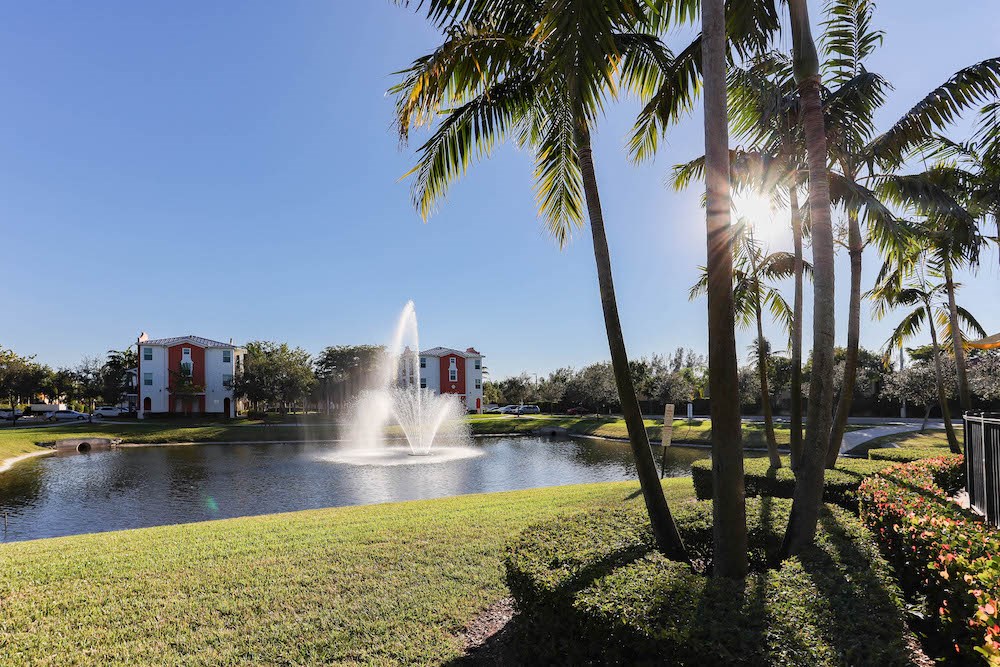 lush landscaping round lake with fountain