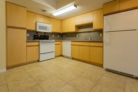 a kitchen with white appliances and wooden cabinets