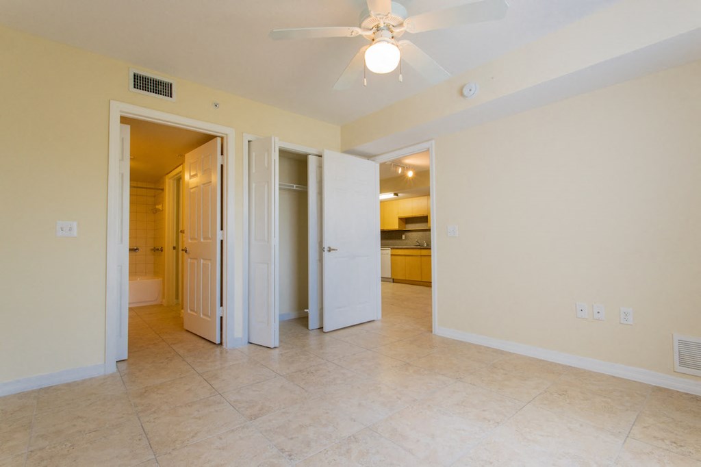 bedroom with ceiling fan and large closet