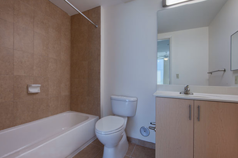 bathroom with tile tub surround