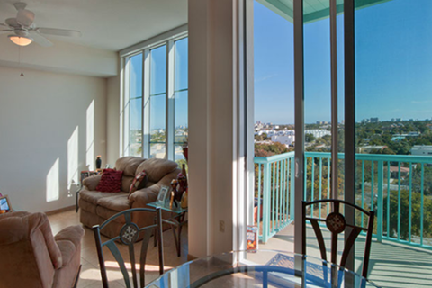 large windows and sliding glass doors leading to balcony