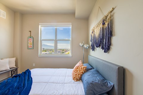 a small bedroom with a bed and a window