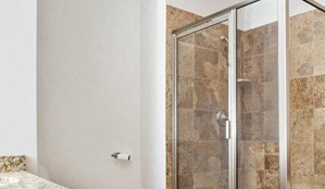 a bathroom with a tub and a shower and a sink