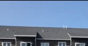 an apartment building with a sign in front of it