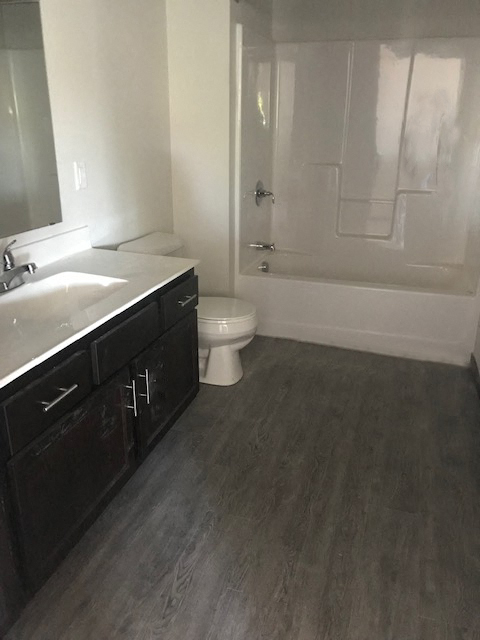 an empty bathroom with a toilet and a sink