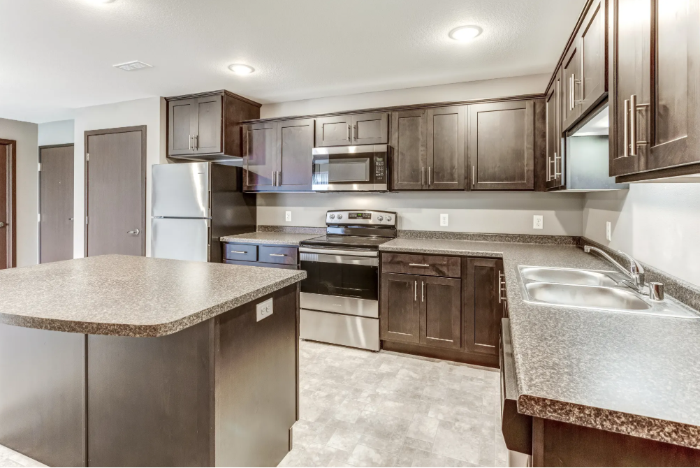a kitchen with stainless steel appliances and granite counter tops