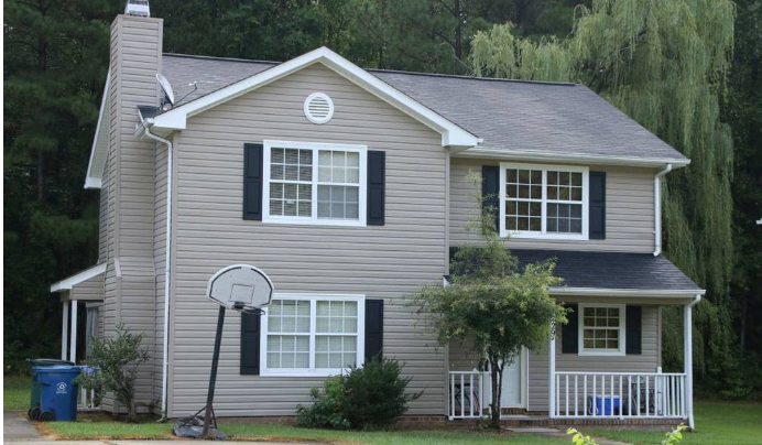 a house with a basketball hoop in front of it