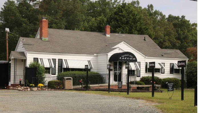 a white house with a black and white sign on the front