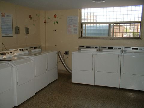 the laundry room is full of washers and dryers
