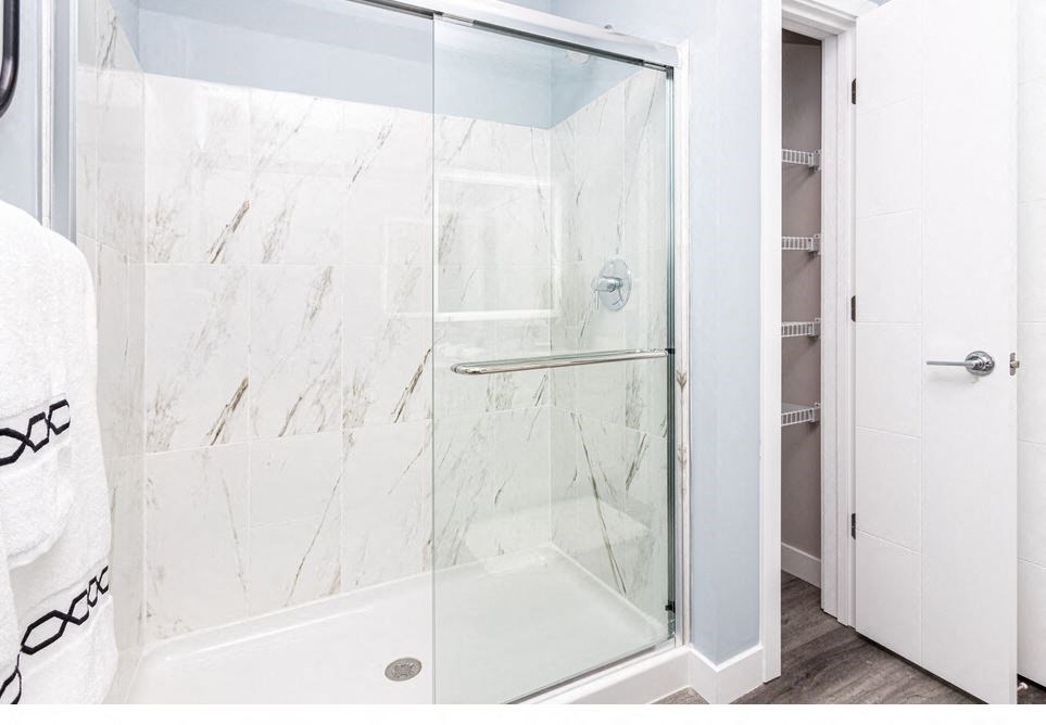 a bathroom with a shower with a glass door