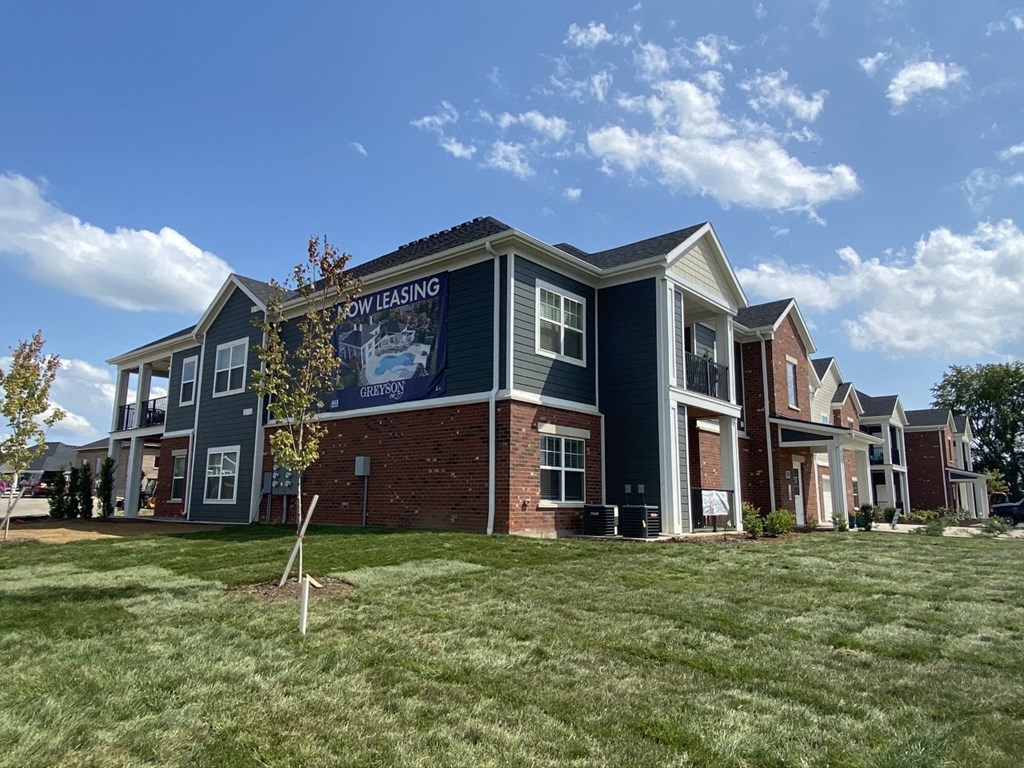 an apartment building with a large sign on the side of it