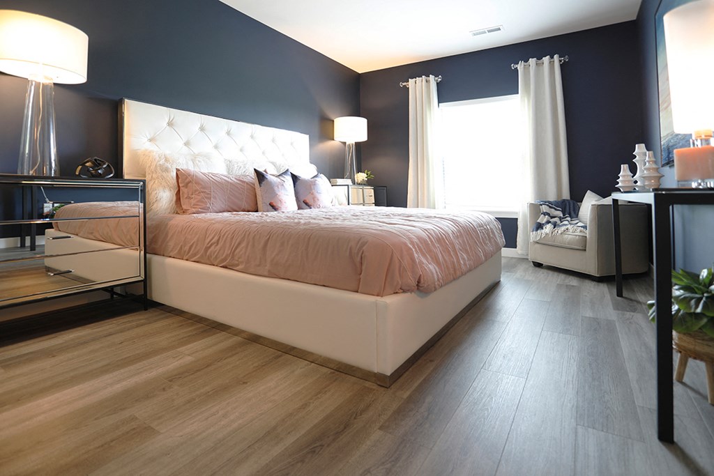 a bedroom with blue walls and a white bed